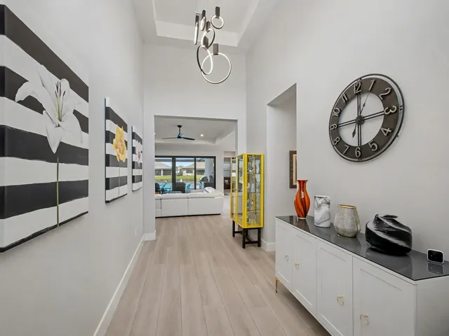 a view of a hallway with entryway wooden floor and front door