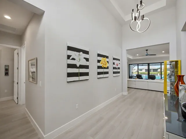 a view of a hallway with wooden floor and windows