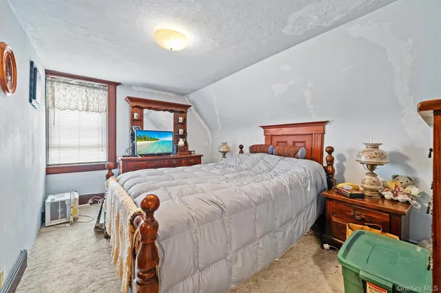 a bedroom with a bed and a table in it