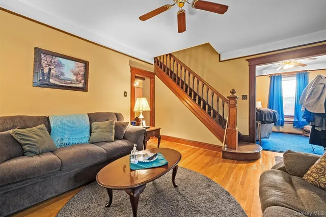 a living room with furniture and a dining table