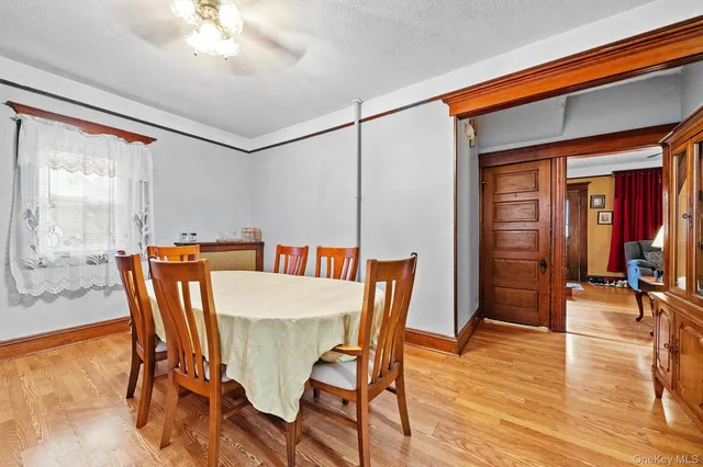 a view of a dining room with furniture wooden floor and chandelier
