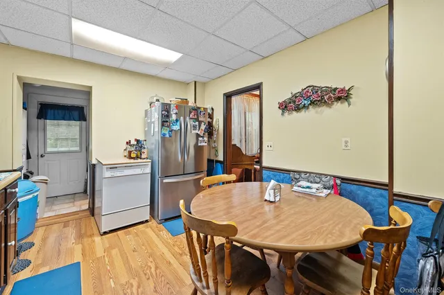 a dining room with furniture and wooden floor