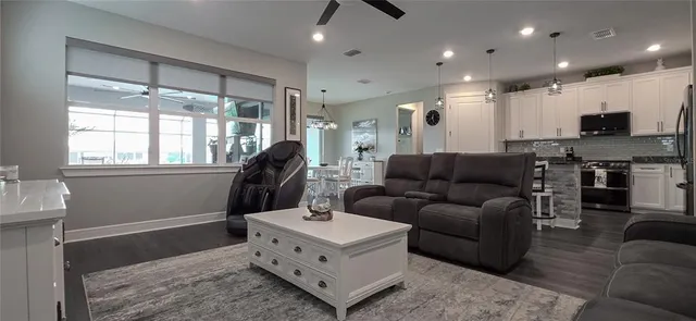 a kitchen with a refrigerator a stove a sink and cabinets