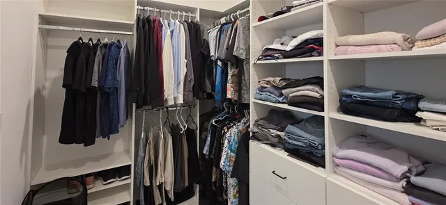 a bathroom with a sink vanity granite tub and shower
