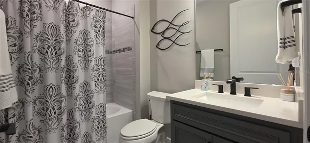 a view of a patio with chairs and a table under an umbrella
