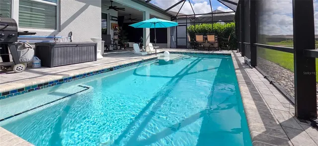 a backyard of a house with lots of green space and wooden fence