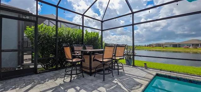 a view of a white building among the street and palm trees