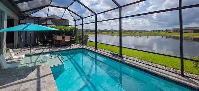 an aerial view of a residential building with outdoor space and seating
