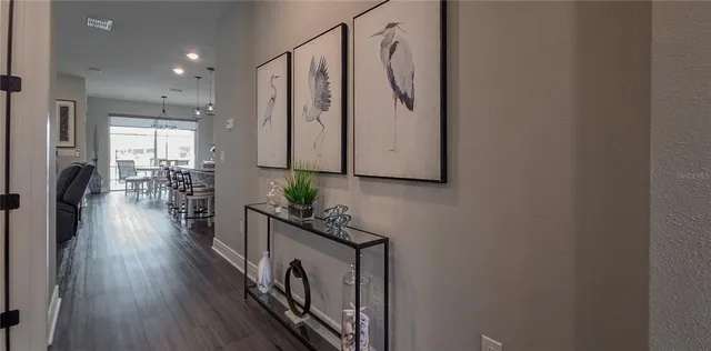 a dining room with furniture and a potted plant