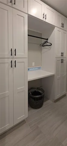 a view of storage and utility room with wooden floor