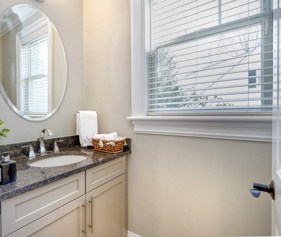 52 Thorpe Road Needham, MA 02494 - Photo 14 of 39 a bathroom with a granite countertop sink and a mirror