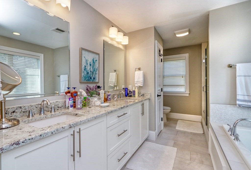 52 Thorpe Road Needham, MA 02494 - Photo 21 of 39 a spacious bathroom with a granite countertop sink mirror and a toilet