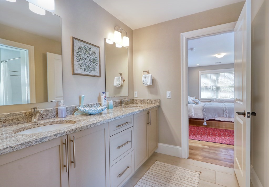 52 Thorpe Road Needham, MA 02494 - Photo 27 of 39 a spacious bathroom with a granite countertop sink and a mirror
