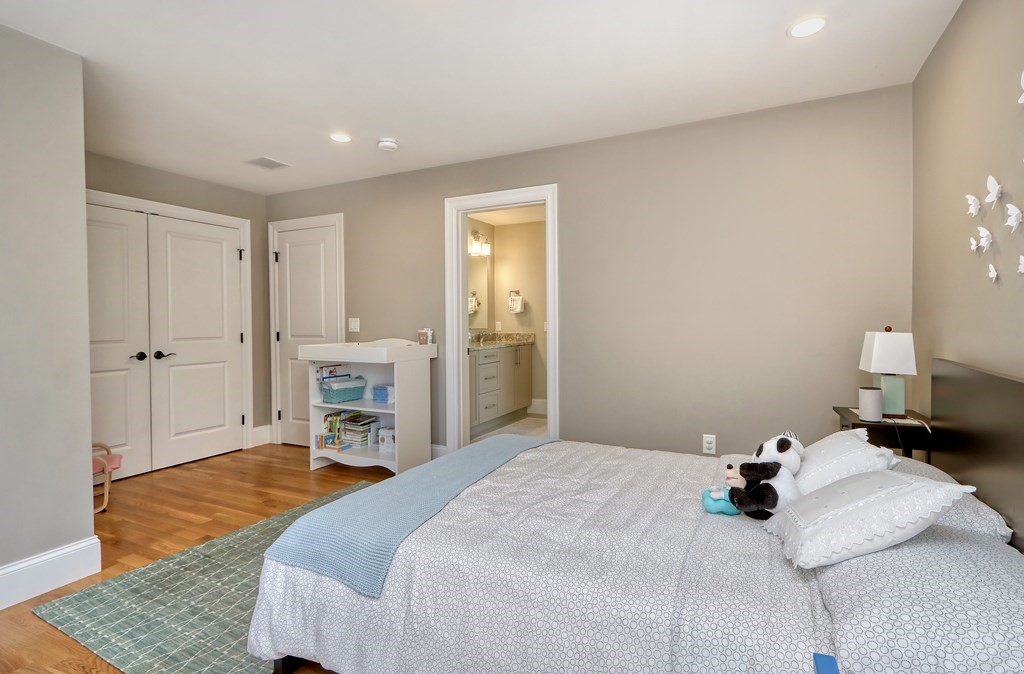 52 Thorpe Road Needham, MA 02494 - Photo 30 of 39 a bedroom with a bed and a fireplace