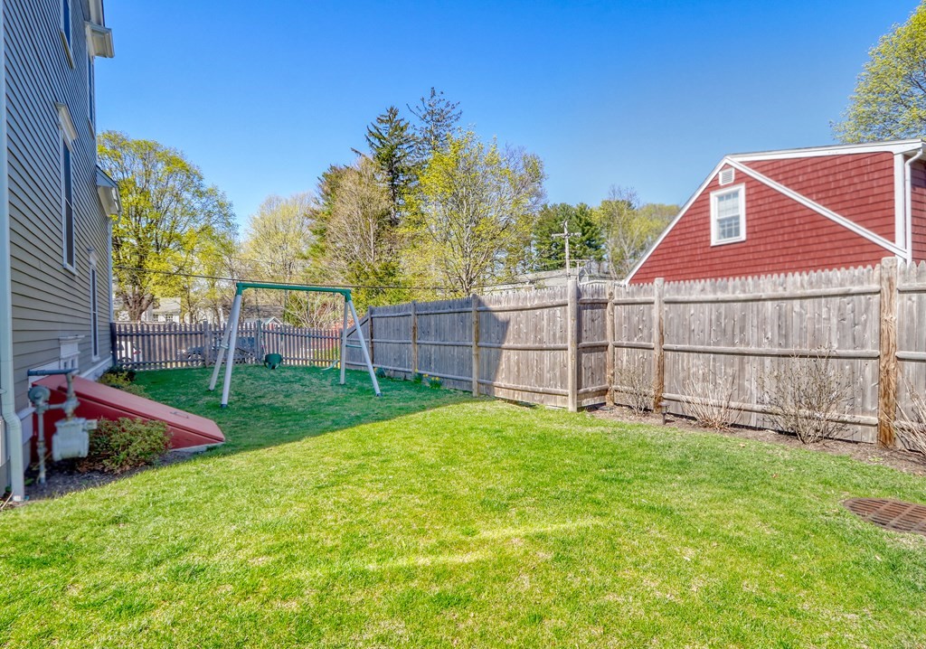 52 Thorpe Road Needham, MA 02494 - Photo 35 of 39 a view of a backyard with a garden and deck