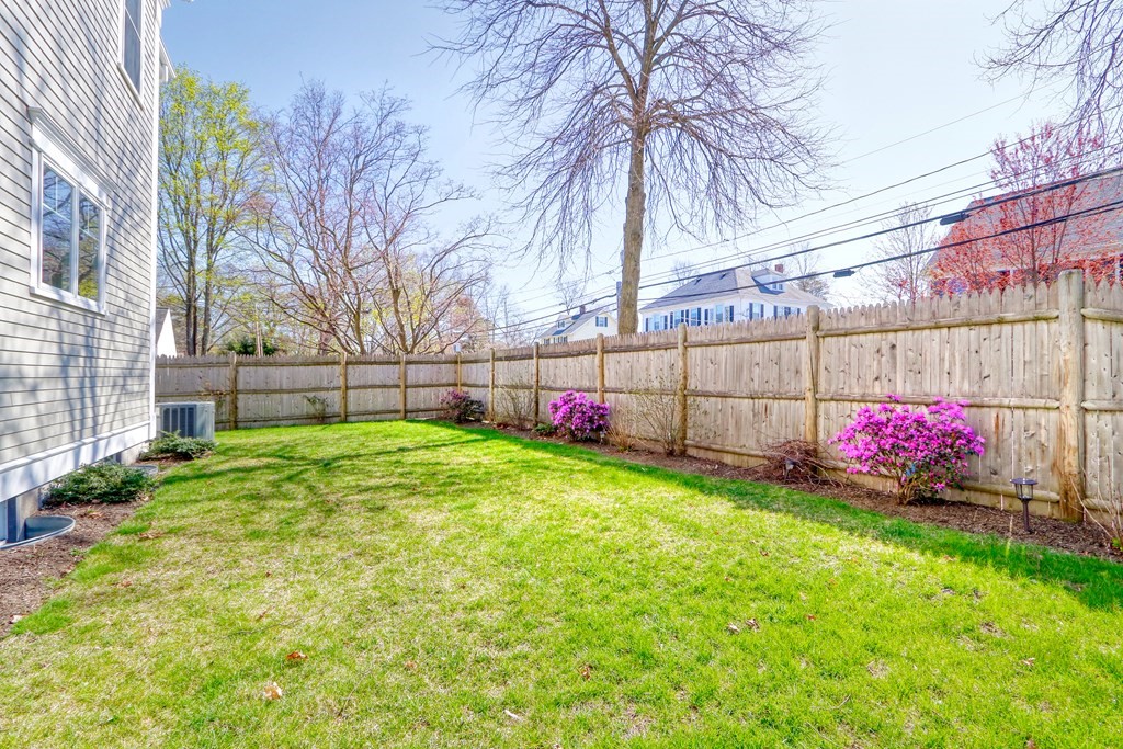 52 Thorpe Road Needham, MA 02494 - Photo 37 of 39 a view of backyard with a huge green area and wooden fence