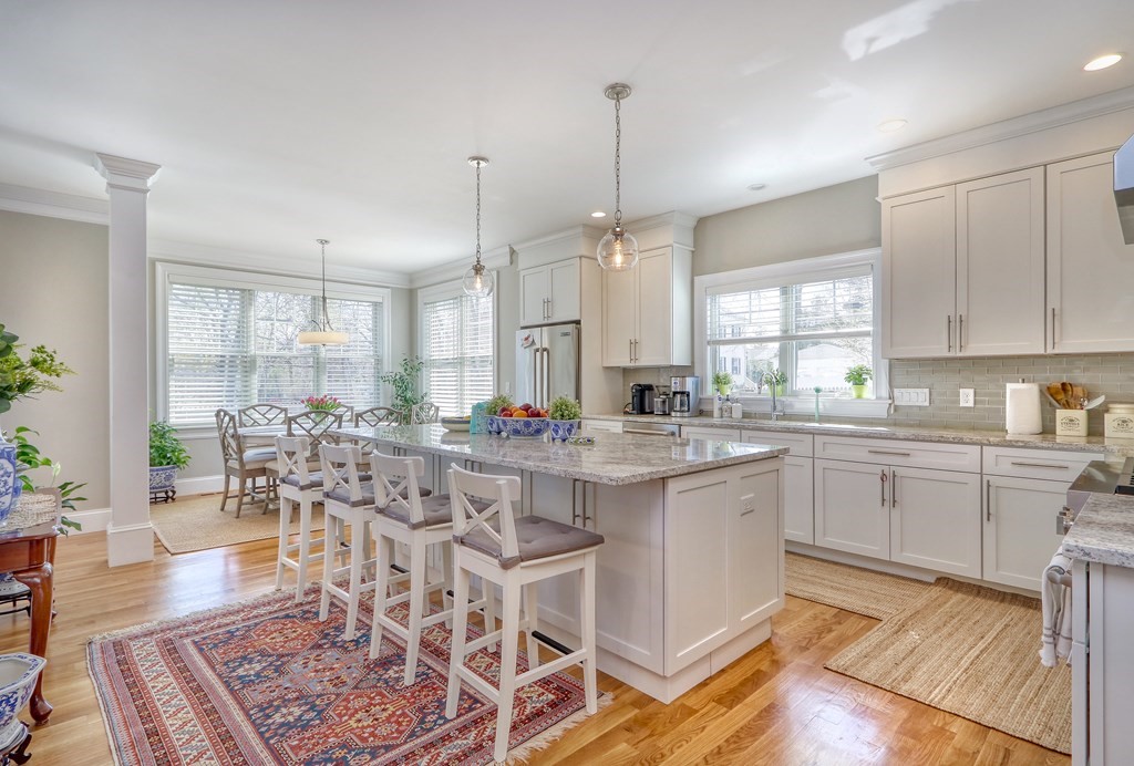 52 Thorpe Road Needham, MA 02494 - Photo 8 of 39 a large kitchen with kitchen island granite countertop a table chairs sink and cabinets