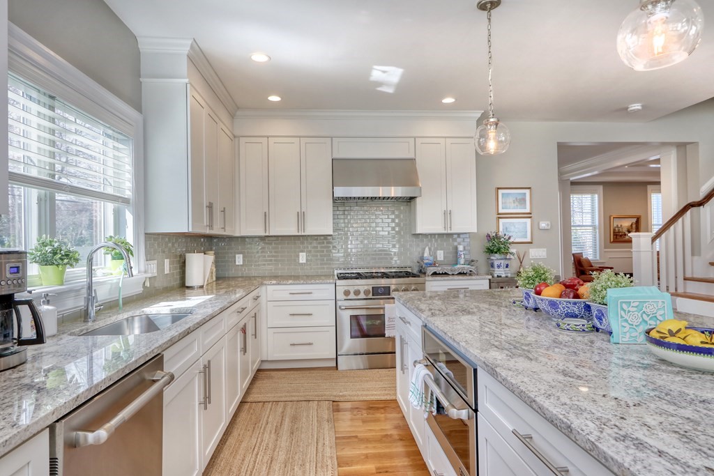 52 Thorpe Road Needham, MA 02494 - Photo 10 of 39 a kitchen with stainless steel appliances granite countertop a sink stove and refrigerator