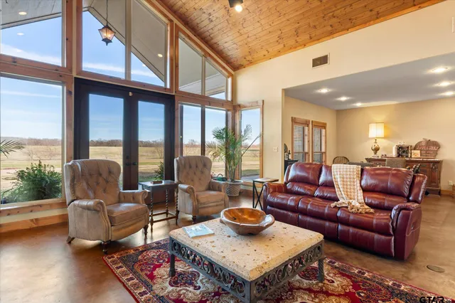 a living room with furniture and a floor to ceiling window