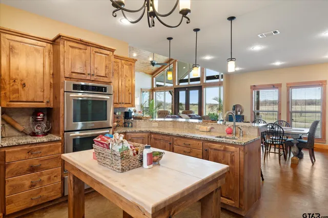 a kitchen with sink refrigerator and cabinets