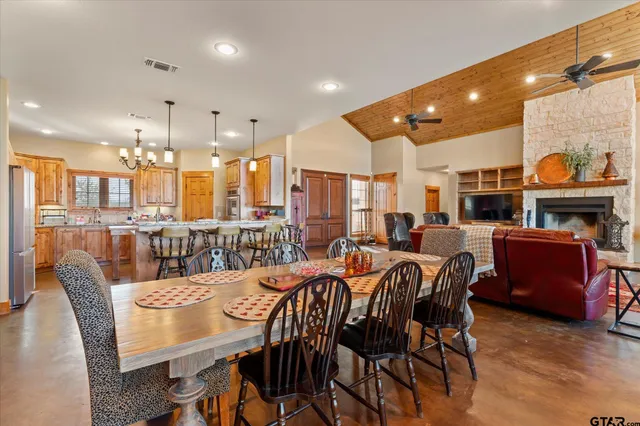 a large kitchen with a table and chairs
