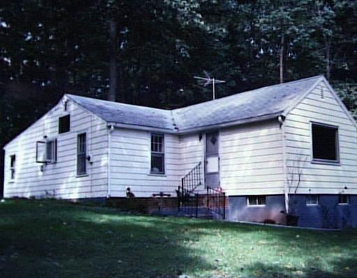 a front view of house with yard and outdoor seating