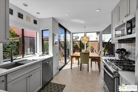a kitchen with stainless steel appliances kitchen island granite countertop a stove and a sink