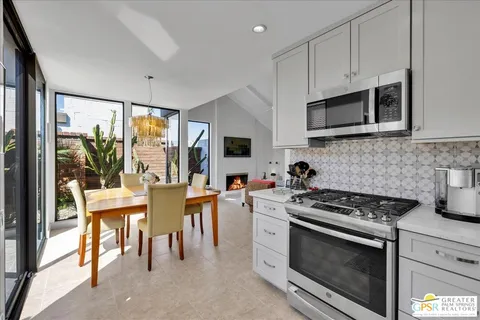 a kitchen with stainless steel appliances a stove a sink a microwave a refrigerator and cabinets