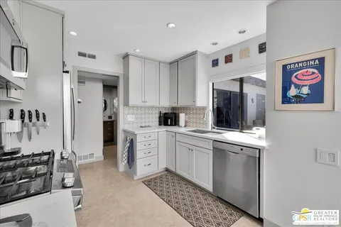 a kitchen with a sink stove and refrigerator