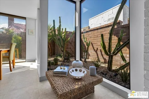 view of living room with furniture and floor to ceiling window
