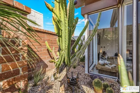 a view of a patio with table and chairs and potted plants
