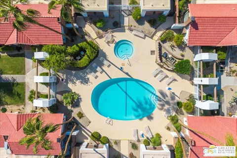 a view of a house with swimming pool and sitting area