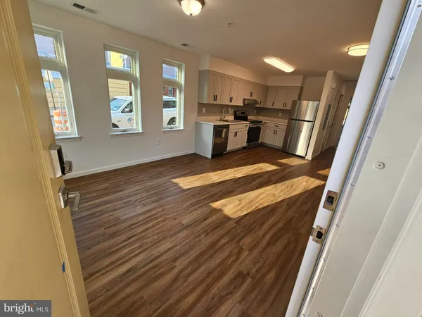 a view of kitchen with sink and refrigerator