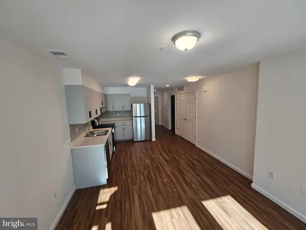 a kitchen with stainless steel appliances a refrigerator and a stove top oven