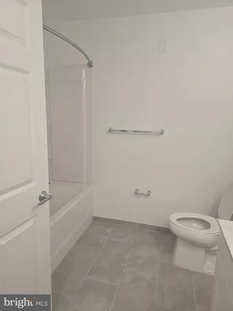 a bathroom with a toilet and a bathtub