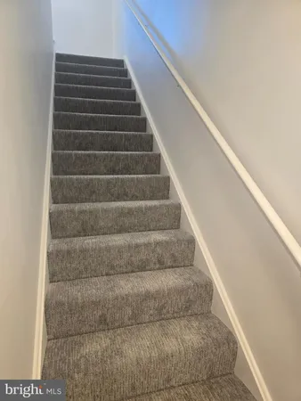 a view of staircase with white walls