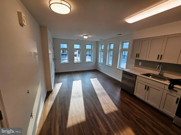 a view of kitchen with wooden floor and electronic appliances