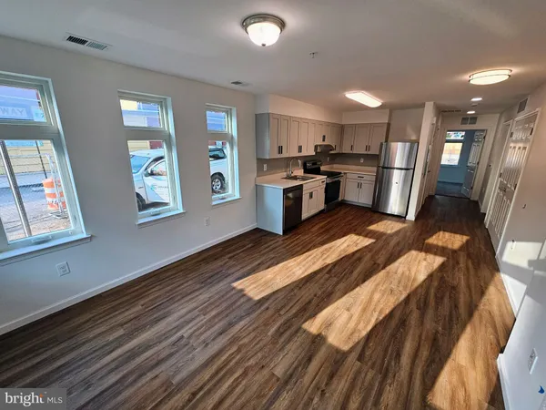 a kitchen with stainless steel appliances granite countertop a refrigerator and stove