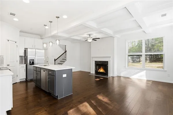 a kitchen that has a sink a stove and a refrigerator