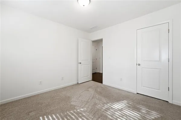 an empty room that has a grey walls