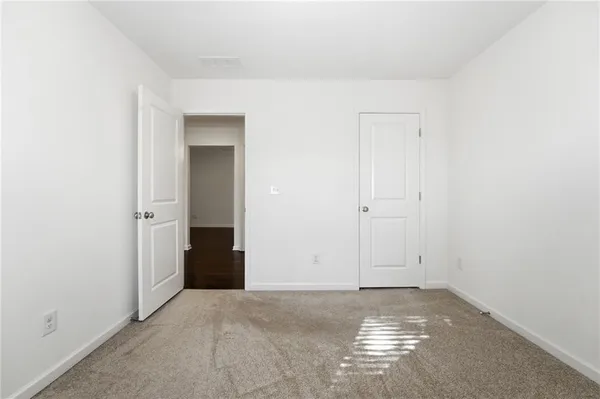 an empty room with a window and a ceiling fan