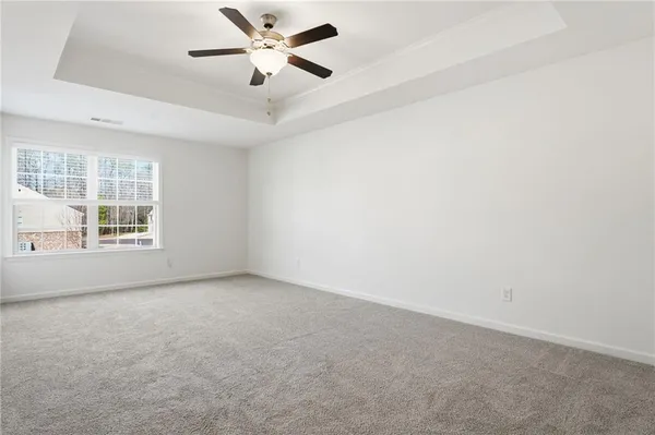 an empty room with a empty space and windows