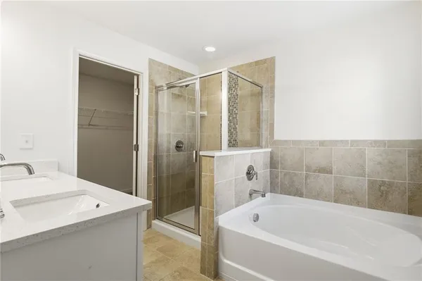 a bathroom with a bathtub and shower