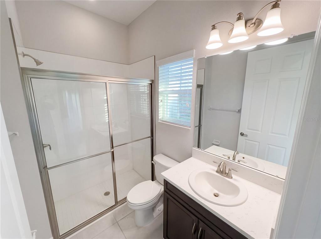 11277 Rustic Timber Loop San Antonio, FL 33576 - Photo 18 of 55 a bathroom with a sink toilet and shower