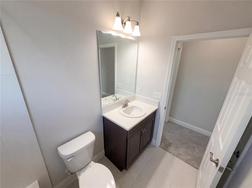 11277 Rustic Timber Loop San Antonio, FL 33576 - Photo 27 of 55 a bathroom with a sink toilet and mirror