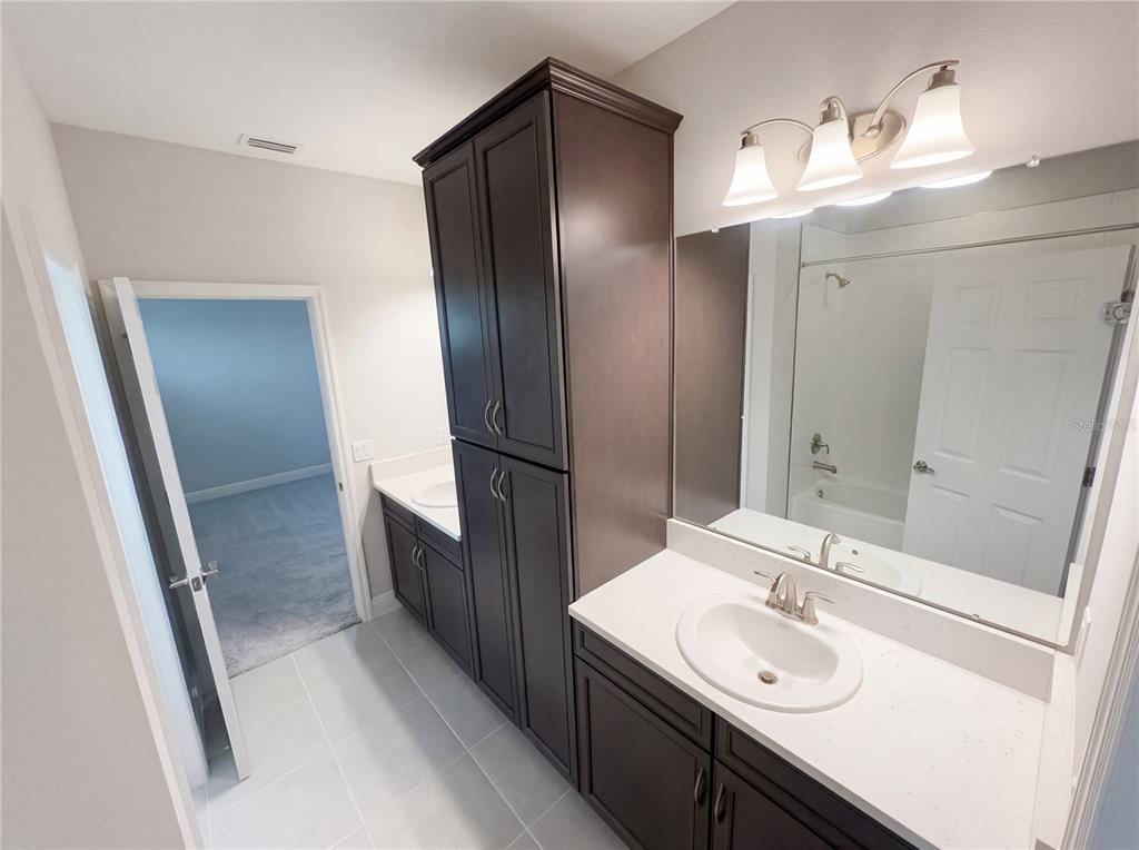 11277 Rustic Timber Loop San Antonio, FL 33576 - Photo 29 of 55 a bathroom with a sink and mirror