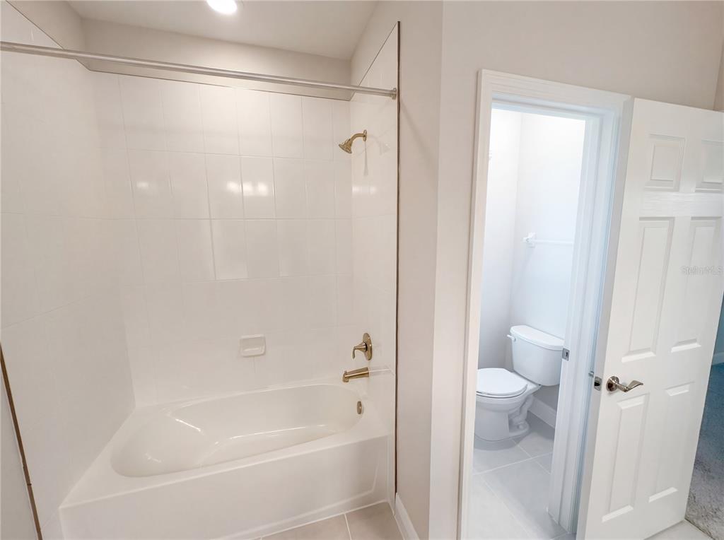 11277 Rustic Timber Loop San Antonio, FL 33576 - Photo 30 of 55 a bathroom with a bathtub and a shower