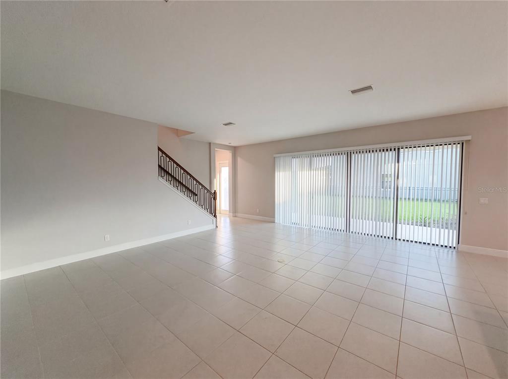 11277 Rustic Timber Loop San Antonio, FL 33576 - Photo 3 of 55 a view of an empty room with a window