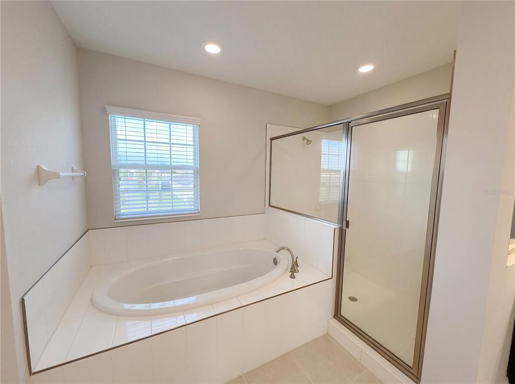 11277 Rustic Timber Loop San Antonio, FL 33576 - Photo 32 of 55 a white bath tub sitting in a bathroom