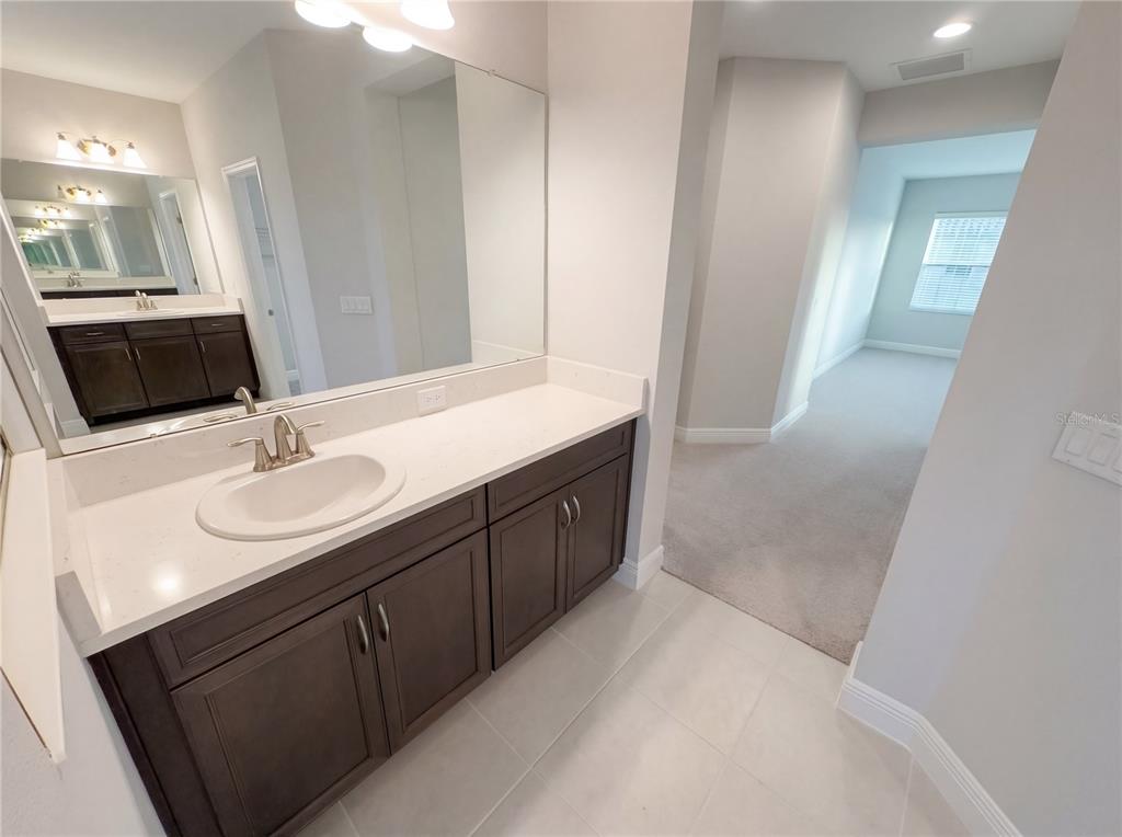 11277 Rustic Timber Loop San Antonio, FL 33576 - Photo 36 of 55 a bathroom with a sink and a mirror